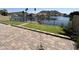 Waterfront backyard with a brick patio, turf lawn, and wrought iron fence for privacy at 20713 N 56Th Ave, Glendale, AZ 85308