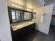 Bathroom vanity with double sinks, granite countertop, and dark wood cabinets at 20713 N 56Th Ave, Glendale, AZ 85308