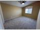 Neutral bedroom with a ceiling fan, carpeted floors and a bright window at 20713 N 56Th Ave, Glendale, AZ 85308