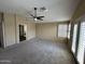 Spacious bedroom with plush carpeting, ceiling fan, and access to the backyard at 20713 N 56Th Ave, Glendale, AZ 85308