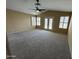 Spacious bedroom with plush carpeting, ceiling fan, and backyard access at 20713 N 56Th Ave, Glendale, AZ 85308