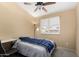 A bright bedroom offers plantation shutters, ceiling fan, desk, and comfortable bed at 20713 N 56Th Ave, Glendale, AZ 85308