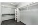 Walk-in closet with ample shelving and storage solutions in the primary bathroom at 20713 N 56Th Ave, Glendale, AZ 85308
