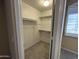 Walk-in closet features ample shelving and is lit from a window at 20713 N 56Th Ave, Glendale, AZ 85308