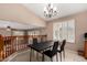 Charming dining area with vaulted ceiling, modern lighting, and shuttered windows adjacent to the living room at 20713 N 56Th Ave, Glendale, AZ 85308