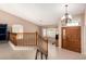 Bright entryway features a wooden staircase and front door beneath an elegant chandelier at 20713 N 56Th Ave, Glendale, AZ 85308