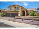 Charming two-story home with a tile roof, arched windows, and a well-manicured front yard at 20713 N 56Th Ave, Glendale, AZ 85308