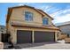 Spacious three-car garage with brick paved driveway and tan stucco exterior at 20713 N 56Th Ave, Glendale, AZ 85308
