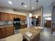 Kitchen boasts wood cabinets, granite countertops, stainless appliances and large island at 20713 N 56Th Ave, Glendale, AZ 85308