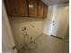 Laundry room with cabinets, washer hookups, tile flooring and door to outside at 20713 N 56Th Ave, Glendale, AZ 85308