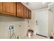Spacious laundry room with ample cabinet space, perfect for efficient home management at 20713 N 56Th Ave, Glendale, AZ 85308
