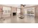 Spacious living area with fireplace, ceiling fan, and sliding doors to the patio with a lake view at 20713 N 56Th Ave, Glendale, AZ 85308