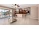 Open living space with access to a patio overlooking the lake and a view of the kitchen at 20713 N 56Th Ave, Glendale, AZ 85308