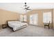 Relaxing primary bedroom with a vaulted ceiling, ceiling fan, shuttered windows, and private access to the backyard at 20713 N 56Th Ave, Glendale, AZ 85308
