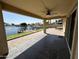 Covered patio boasts waterfront views, ceiling fan, and tiled flooring for outdoor entertaining at 20713 N 56Th Ave, Glendale, AZ 85308