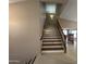 View of the staircase with wooden banister leading to the upper level of the home at 20713 N 56Th Ave, Glendale, AZ 85308
