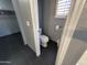 A view of the water closet with tile flooring at 20713 N 56Th Ave, Glendale, AZ 85308