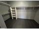 A walk-in closet with ample shelving and dark tile flooring at 20713 N 56Th Ave, Glendale, AZ 85308
