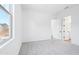 A carpeted bedroom with white walls and trim, a window, and an open doorway at 22825 E Alyssa Rd, Queen Creek, AZ 85142