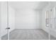 Bright bedroom features plush carpeting, neutral walls, and natural light from windows on opposite sides at 22825 E Alyssa Rd, Queen Creek, AZ 85142