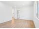 Bright bedroom with wood-look floors and a large window at 22825 E Alyssa Rd, Queen Creek, AZ 85142