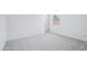 A carpeted bedroom with white walls and trim, a baseboard, and a door and window at 22825 E Alyssa Rd, Queen Creek, AZ 85142