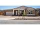 Charming single-story home showcasing a two-car garage, neutral stucco, and manicured landscaping at 22825 E Alyssa Rd, Queen Creek, AZ 85142