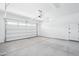 A clean and spacious two-car garage with white walls and concrete floors at 22825 E Alyssa Rd, Queen Creek, AZ 85142