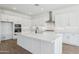 Bright kitchen with a large island, stainless steel appliances, and modern white cabinets at 22825 E Alyssa Rd, Queen Creek, AZ 85142