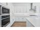Modern kitchen featuring stainless steel appliances, white cabinets, and a large island at 22825 E Alyssa Rd, Queen Creek, AZ 85142