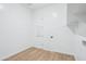 Simple laundry room with tile floors, modern door, and utility connections at 22825 E Alyssa Rd, Queen Creek, AZ 85142
