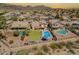 Expansive aerial shot of houses with private pools and well-maintained landscaping under a vibrant sunset at 2333 E Taxidea Way, Phoenix, AZ 85048