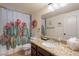 Bathroom with granite counters, vanity, framed mirror and colorful cactus shower curtain at 2333 E Taxidea Way, Phoenix, AZ 85048