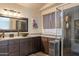 Bathroom featuring a granite countertop, basin sink, and a black-framed vanity mirror at 2333 E Taxidea Way, Phoenix, AZ 85048
