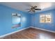 Bright bedroom with wood-look floors, a window, and a ceiling fan at 2333 E Taxidea Way, Phoenix, AZ 85048