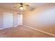 Bedroom featuring neutral carpet, a double door closet, and a ceiling fan at 2333 E Taxidea Way, Phoenix, AZ 85048