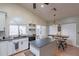 Beautiful kitchen features white cabinets, dark countertops, an island, and a breakfast bar at 2333 E Taxidea Way, Phoenix, AZ 85048