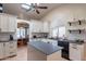 Modern kitchen featuring an island, a breakfast bar, white cabinets, and stainless steel appliances at 2333 E Taxidea Way, Phoenix, AZ 85048