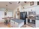Stylish kitchen featuring an island, breakfast bar, and modern stainless steel appliances at 2333 E Taxidea Way, Phoenix, AZ 85048