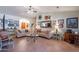 Bright and airy living room with tile floors, an orange front door and decorated wall art at 2333 E Taxidea Way, Phoenix, AZ 85048