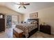 Main bedroom featuring a ceiling fan, private patio access, and stylish furnishings at 2333 E Taxidea Way, Phoenix, AZ 85048
