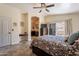 Bedroom with neutral colors, private patio access, and view of ensuite bath at 2333 E Taxidea Way, Phoenix, AZ 85048