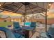 Inviting pool area with comfortable seating under a gazebo, set against the backdrop of a lovely home at 2333 E Taxidea Way, Phoenix, AZ 85048
