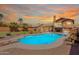 Backyard featuring a pool, a patio, desert landscaping, and a two-story home in the background at 2333 E Taxidea Way, Phoenix, AZ 85048