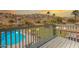 Scenic view of a pool and backyard with desert landscaping, captured from a wooden deck with string lights at 2333 E Taxidea Way, Phoenix, AZ 85048
