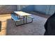 Backyard with a stone-stamped concrete patio featuring a table and benches perfect for outdoor dining at 2397 E Winchester Pl, Chandler, AZ 85286