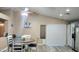Open-concept kitchen and dining area with sleek countertops, white cabinetry, and modern appliances at 2397 E Winchester Pl, Chandler, AZ 85286