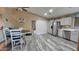 Kitchen and dining area with sleek countertops, white cabinetry, and stainless appliances and ceiling fan at 2397 E Winchester Pl, Chandler, AZ 85286