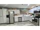 Spacious kitchen featuring stainless steel appliances, white cabinets, and wood-look flooring at 2397 E Winchester Pl, Chandler, AZ 85286