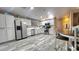 Open kitchen featuring stainless steel appliances, white cabinets, wood-look flooring, and breakfast nook at 2397 E Winchester Pl, Chandler, AZ 85286